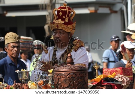 DENPASAR, INDONESIA - MAY 13: A Balinese Priest or holy man conducting blessings at a  Royal Ngaben or cremation ceremony in Ubud, Denpasar, Bali, Indonesia on May 13, 2013.