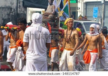BANGKOK, THAILAND - OCTOBER 19: Traditional warriors or Mah Song with piercings in a bizarre ritual of mutilation for the Phuket Vegetarian Festival in Phuket, Bangkok, Thailand on October 19, 2012.