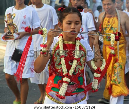 PHUKET, THAILAND - OCTOBER 11: A traditional female Mah Song or warrior in the street procession of the Phuket Vegetarian Festival in Phuket Town, Phuket, Thailand on the 11th October, 2013.