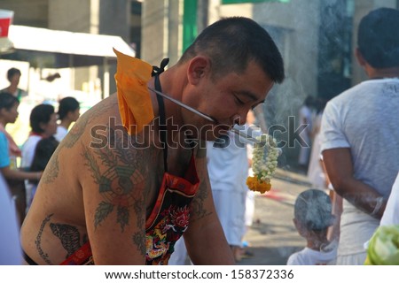 PHUKET, THAILAND - OCTOBER 11: A traditional Mah Song or warrior in the street procession of the Phuket Vegetarian Parade in Phuket Town, Phuket, Thailand on the 11th October, 2013.