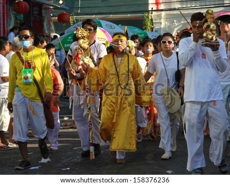 PHUKET, THAILAND - OCTOBER 11: A traditional Mah Song or warrior in the street procession of the Phuket Vegetarian Festival in Phuket Town, Phuket, Thailand on the 11th October, 2013.