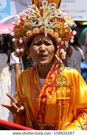 PHUKET, THAILAND - OCTOBER 13: A traditional female mah song or warrior in the street procession of The Phuket Vegetarian Festival on the 13th October, 2013.