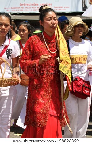 PHUKET, THAILAND - OCTOBER 13: A traditional female mah song or warrior in the street procession of The Phuket Vegetarian Festival on the 13th October, 2013.
