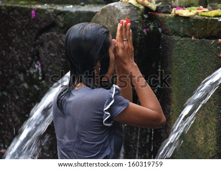 DENPASAR, INDONESIA - May 13: A traditional scene of a Balinese woman bathing in the holy water at Tirta Empil, a Hindu temple near Ubud, Denpasar, Indonesia on 13th May, 2013.