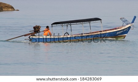 PHANG NGA, THAILAND - MARCH 11: A Moken Sea Gypsy in his traditional long tail boat at Mu Ko Surin National Park, Phang Nga, Thailand on the 11th March, 2014.