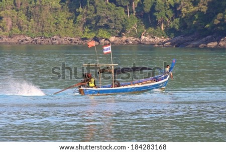 PHANG NGA, THAILAND - MARCH 11: A Moken Sea Gypsy in his traditional long tail boat at Mu Ko Surin National Park, Phang Nga, Thailand on the 11th March, 2014.