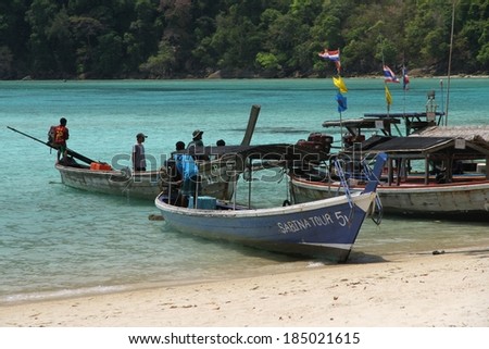 PHANG NGA, THAILAND - MARCH 14: Traditional long tail boats with Moken Sea Gypsies in the shallow water of the Surin Islands, Phang Nga, Thailand on the 14th March, 2014.