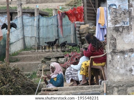 NUWARA ELIYA, SRI LANKA - FEBRUARY 19th: A typical scene of women sitting outside their ramshackle housing of the tea pickers in Nuwara Eliya, Sri Lanka on the 19th February, 2014.