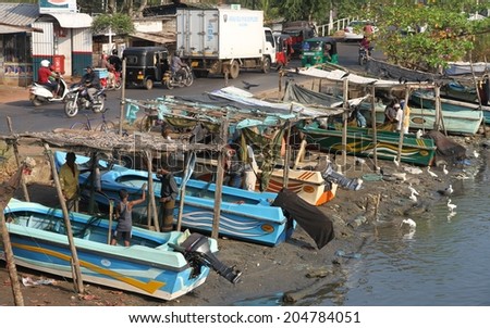 COLOMBO, SRI LANKA - MARCH 1: Fishermen and their fishing boats in the lagoon near the fish markets of Negombo, near Colombo, Sri Lanka on the 1st March, 2014.