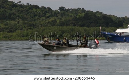 BANGKOK, THAILAND - MAY 14: A military boat with machine gun and military personnel on the water after the military coup Thailand near Tabla Mu Pier, Khao Lak, Bangkok, Thailand on the 14th May, 2014.