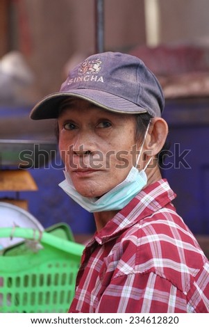 MAE SOT, THAILAND - SEPTEMBER 1: The garbage collector at the fresh food market of Mae Sot, Thailand on the 1st September, 2014.
