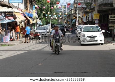 KANCHANABURI, THAILAND - SEPTEMBER 3: A local man on his motor bike in the town of Kanchanaburi, Thailand on the 3rd September, 2014.