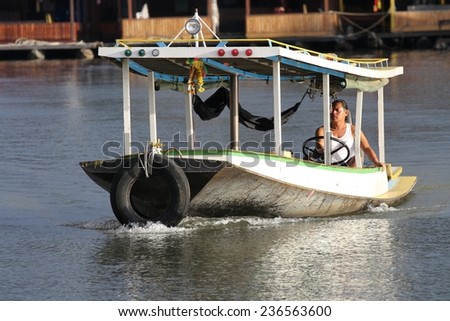 KANCHANABURI, THAILAND - SEPTEMBER 3: A speed boat driven by a local on the River Kwai in the town of Kanchanaburi, Thailand on the 3rd September, 2014.