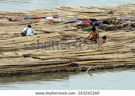 MANDALAY, MYANMAR - NOVEMBER 7:\
A shanty town built on bamboo poles tied together with locals going about their daily lives on the riverbank of the town of Mandalay, Myanmar on the 7th November 2012.