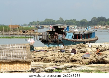 MANDALAY, MYANMAR - NOVEMBER 7:
A shanty town built on bamboo poles tied together with locals going about their daily lives on the riverbank of the town of Mandalay, Myanmar on the 7th November 2012.