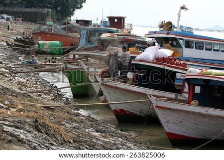 MANDALAY, MYANMAR - NOVEMBER 7:\
The riverbank of the Irrawaddy River lined with traditional boats moored on the banks in the town of Mandalay, Myanmar on the 7th November, 2012.