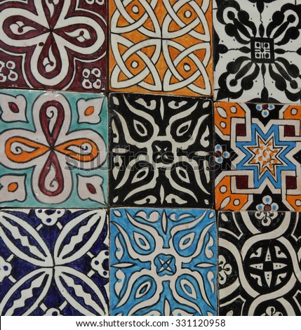 A collection of traditional Moroccan floor or wall decorative hand painted tiles on display in the old town of Marrakesh, Morocco.