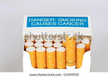 A packet of cigarettes with a warning it causes cancer.