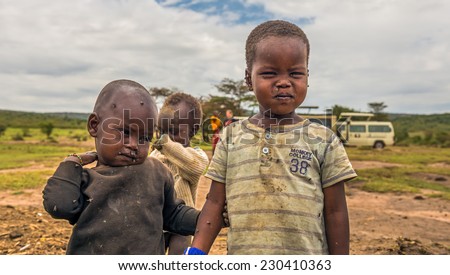 MASAI MARA, KENYA - OCTOBER 17, 2014: Two african boys from Masai tribe in their village. The Maasai are a Nilotic ethnic group living in southern Kenya and northern Tanzania