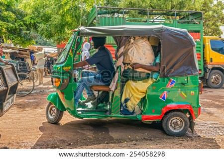 MTO WA MBU, ARUSHA, TANZANIA - OCTOBER 22, 2014 : African taxi taking customers from the local marketplace of Mto Wa Mbu. Mto wa Mbu is an administrative ward in the Arusha Region of Tanzania
