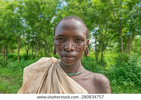SOUTHWESTERN ETHIOPIA - MAY 3, 2015 : Portrait of a young boy from the african tribe Suri with traditionally enlarged Ears