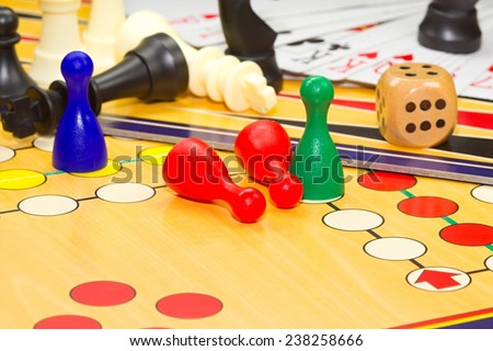 Photo shows a closeup of a various board games including chess and cards.