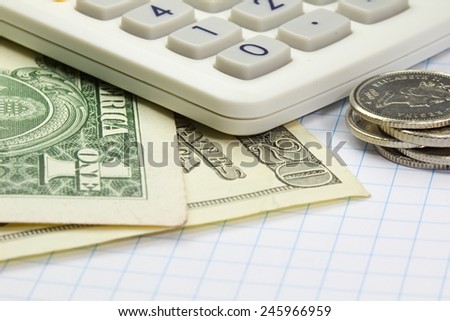 Photo shows a closeup of business calculator and money on a paper.