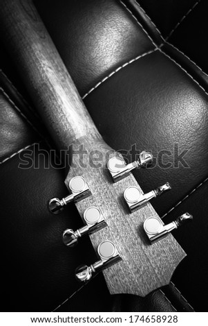 back of guitar headstock show chrome tuner and grain of wood B&W old film processed