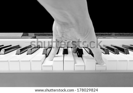 left hand play chord C major on piano B&W film processed