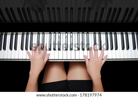 Beautiful Asian woman\'s hands playing on piano and reflection