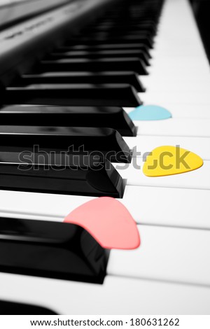 colorful guitar picks on piano