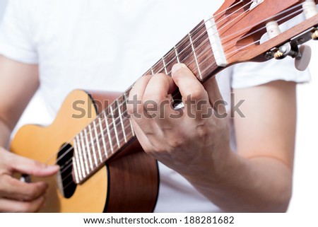 Asian musician plays acoustic guitar, isolated