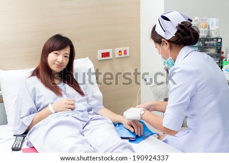 Smiling beautiful asian patient and nurse