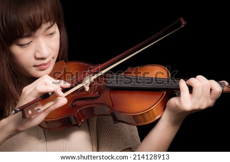 Asian Beautiful Female Musician plays Violin, isolated on black