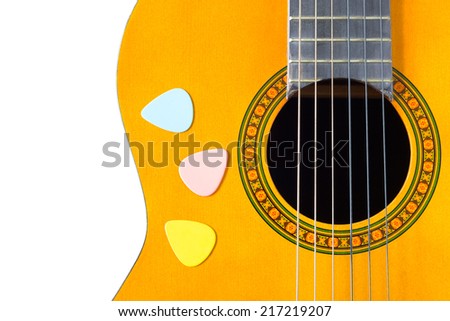 colorful picks on acoustic guitar / classical guitar, isolated on white