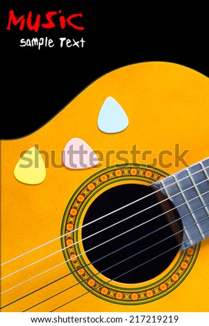 colorful picks on acoustic guitar / classical guitar, isolated on black