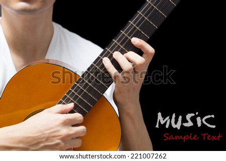 musician , guitarist plays classical / acoustic guitar, isolated on black