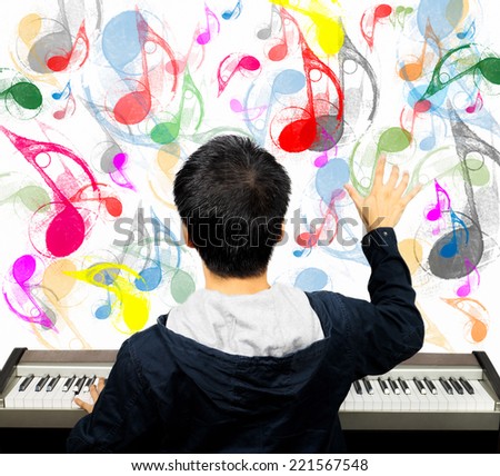 back of asian male musician / pianist / composer arranges music note on imagination