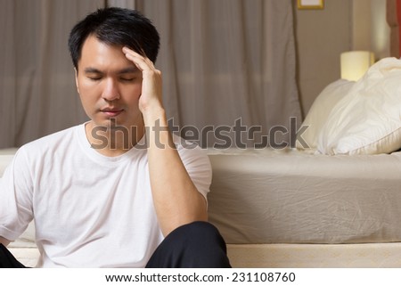 Asian handsome man worry and sleepless all night near the bed