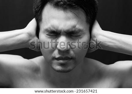 asian handsome man in black and white emotion portrait photo / feel sad ,headache and alone on dark background
