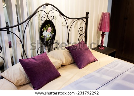 classic iron headboard in master bedroom purple cushion & lamp