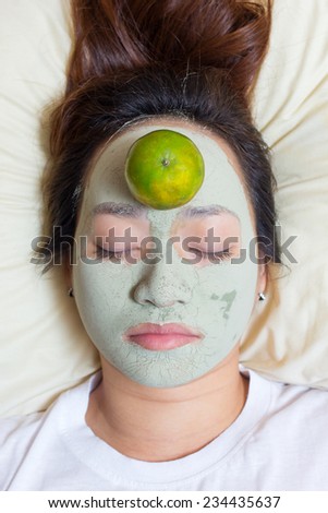 sleeping woman in clay mud facial mask on face on bed , Girl taking care of dry complexion. Beauty nature treatment