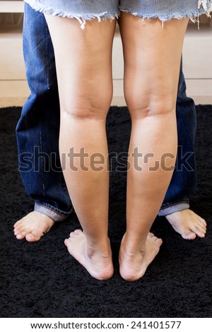 asian husband and his beautiful wife during intimacy , face to face / focus to female legs , sex & health concept