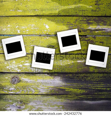 four negative slide film frame on old wood & green lichen for background