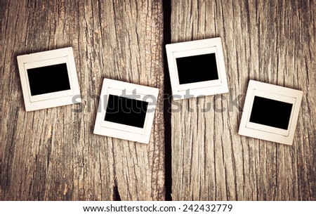 retro photo of four negative slide film frame on old wood for background