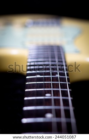 electric guitar focus to fret on fingerboard, shallow depth of field