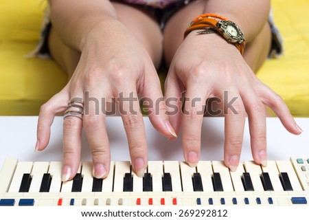 Beautiful Asian woman\'s hands playing on small piano , music keyboard for practice & hobby