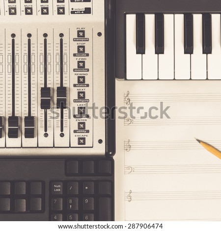 pencil on blank music sheet, studio mixer, piano & keyboard for composer / music production concept background