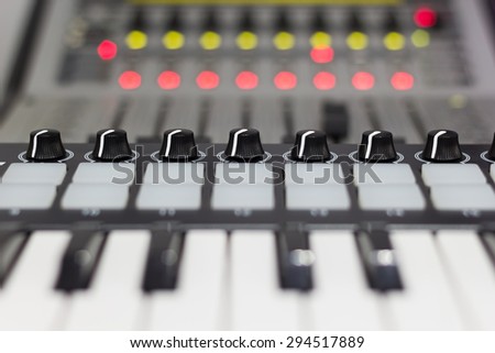 recording studio gears, broadcasting tools, mixer, synthesizer focus to knobs. shallow dept of field for music background