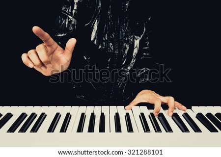 hands of male pianist / musician playing piano + art color filter for music concept